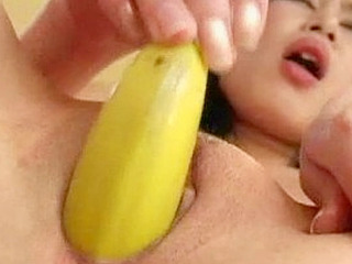 Cute Asian teen drills her snatch with a banana